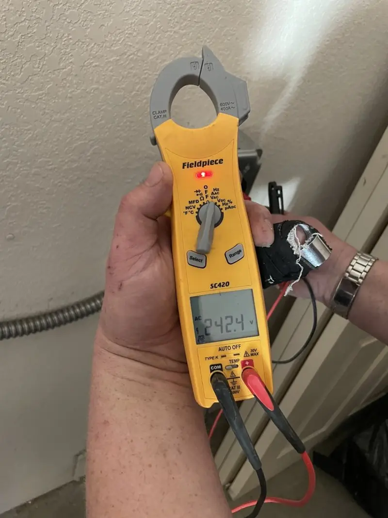 Voltage testing with clamp meter during Outlet Installation in Oakville